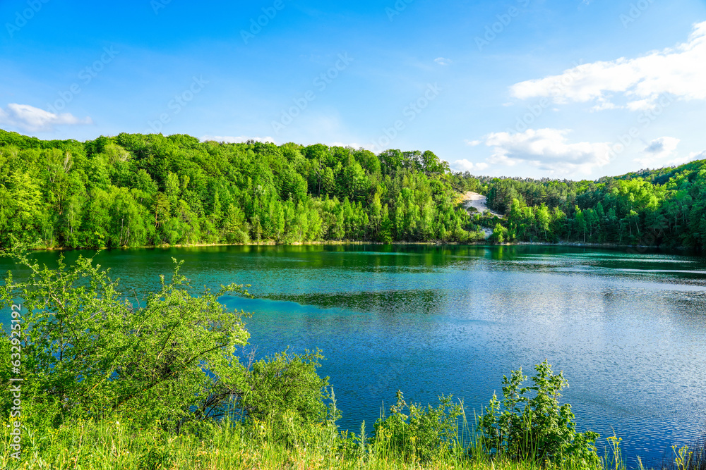 Fototapeta premium Jezioro Turkusowe near Wapnica. Lake in Wolin National Park in Poland. Idyllic landscape with green nature by the lake. Turquoise lake. 