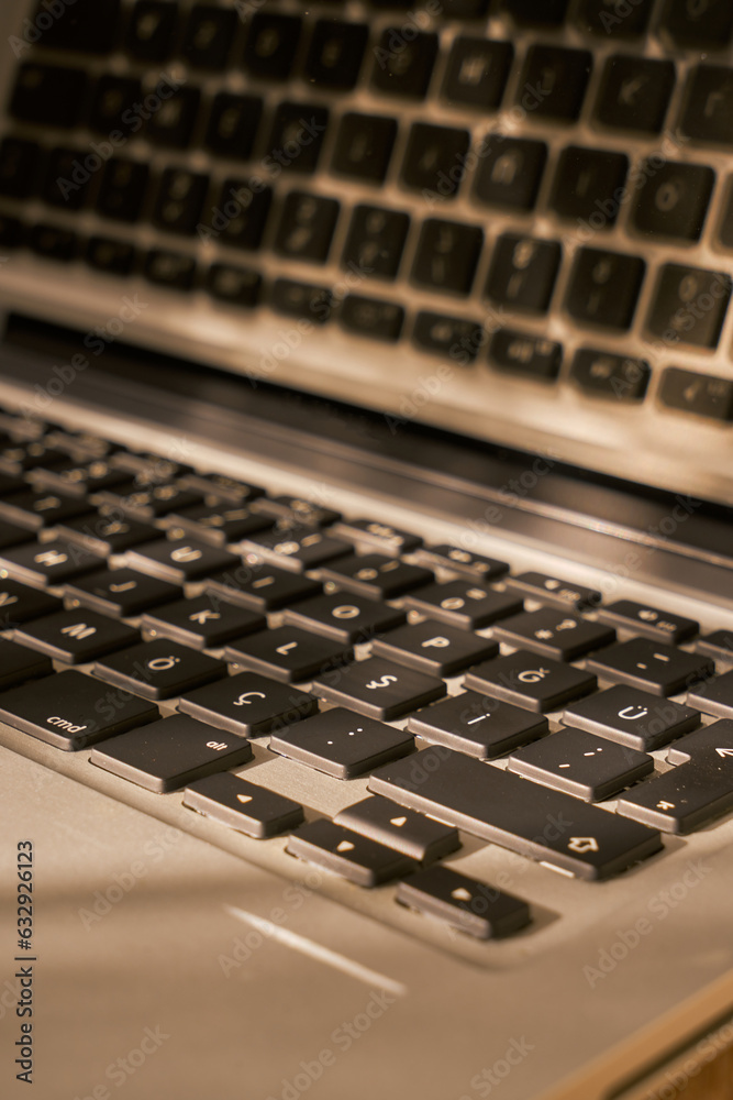 Grey laptop details on a table Grey laptop details on a table