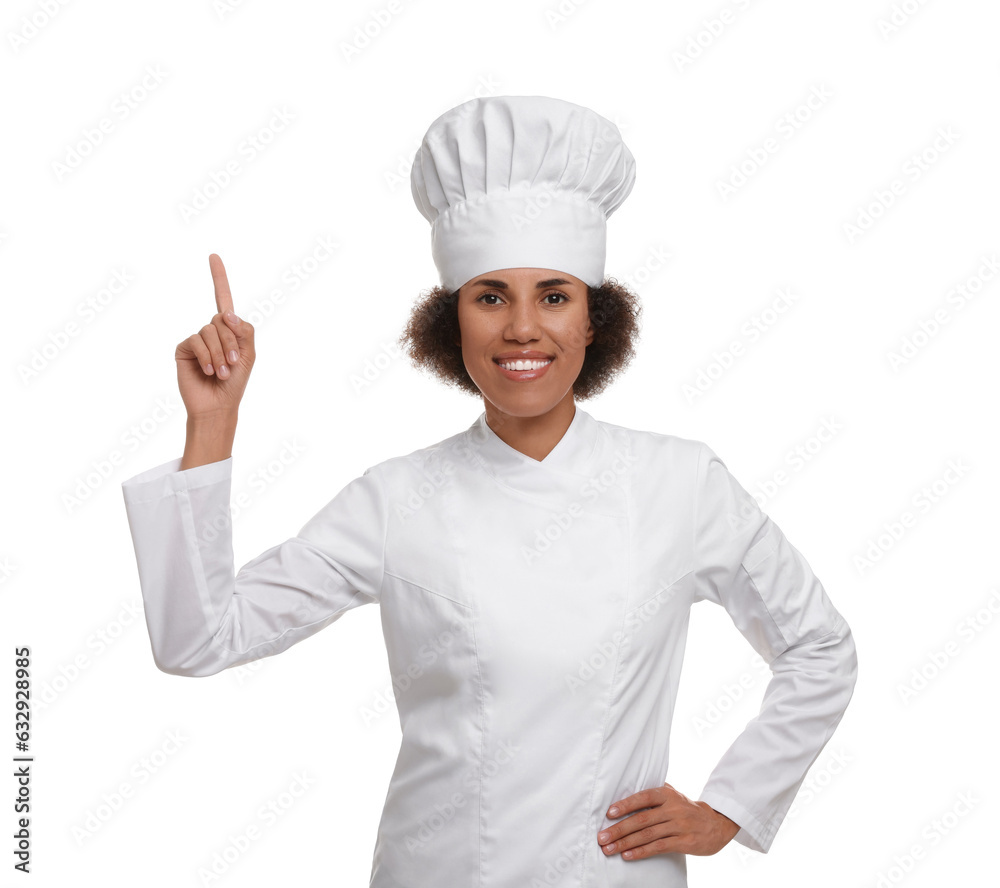 Happy female chef in uniform pointing at something on white background Happy female chef in uniform pointing at something on white background