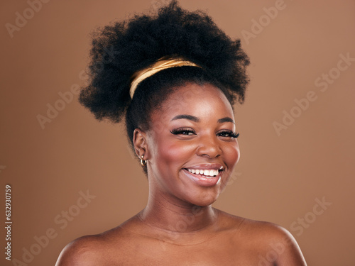 Portrait, natural hair care or happy black woman with afro, self love or smile on a brown studio background. Hairstyle, healthy growth or African model with glow or beauty with aesthetic or wellness