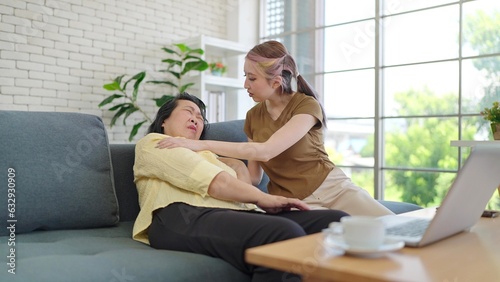 Loving daughter take care of elderly mother while having left chest pain on sofa. Suffering from chest pain or heart attack