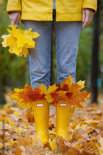 bright autumn. girl in yellow rubber boots walking