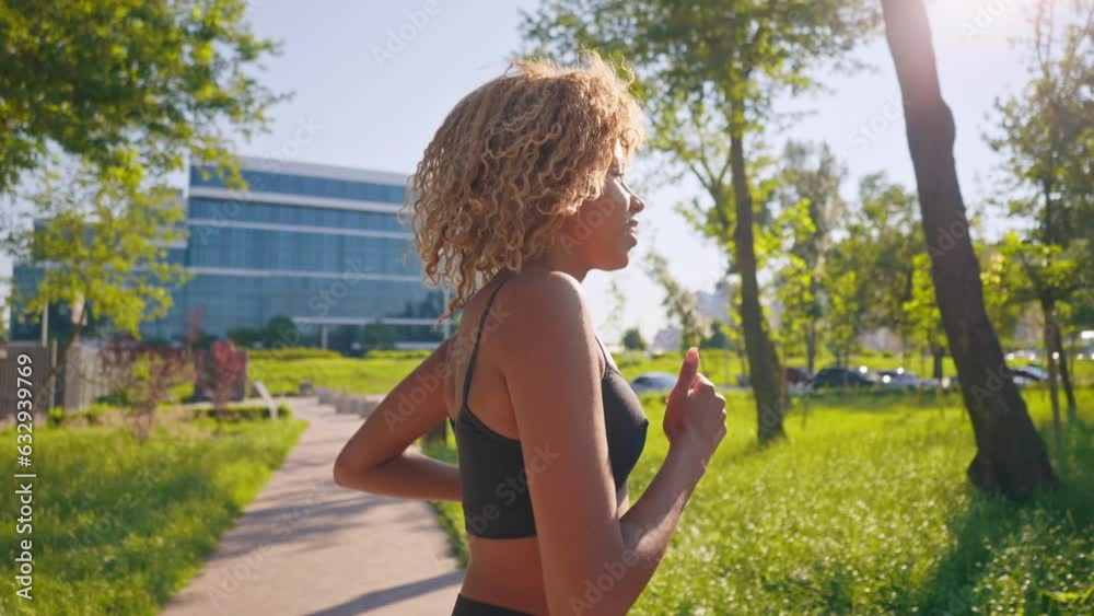 side view jogger with blond hair running in the morning blue sky with sun rays active healthy lifestyle