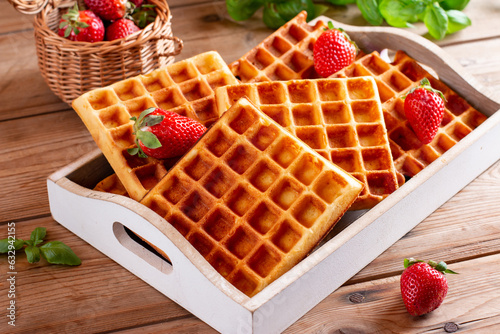 Viennese waffles with strawberry on a wooden table, breakfast, no people