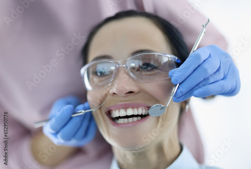 Portrait of woman with her mouth wide open at dentist appointment. Dental Services About Assistance Concept