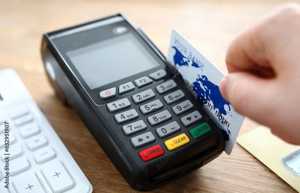 Male hand hold credit card with POS terminal closeup background. Fast payment concept Male hand hold credit card with POS terminal closeup background. Fast payment concept