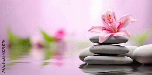 a serene zen garden, focusing on a stack of spa massage stones delicately balanced with pink lily flowers adorning them