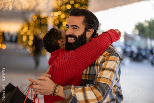 hug of multiracial couple shopping at christmas © PintoArt