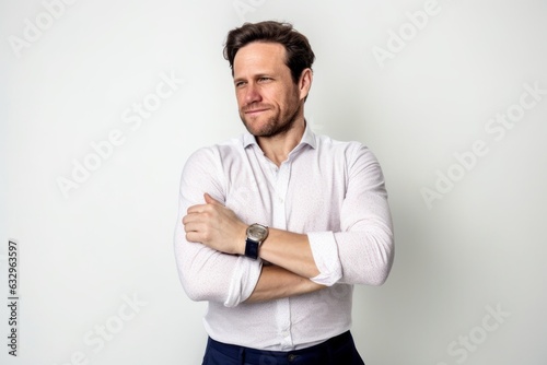 Medium shot portrait photography of a man in his 30s scratching his arm due to atopic dermatitis wearing a chic cardigan against a white background 
