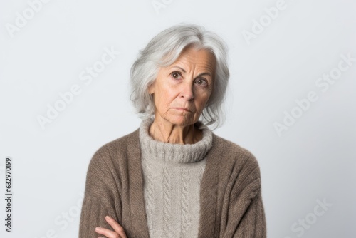 Group portrait photography of a woman in her 20s with a confused and distant expression due to Alzheimer disease wearing a chic cardigan against a white background 