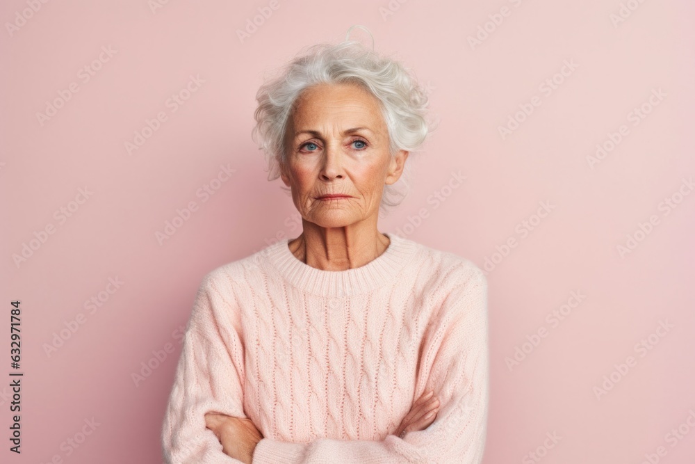 Medium shot portrait photography of a woman in her 50s with a pained and tired expression due to fibromyalgia wearing a cozy sweater against a pastel or soft colors background 