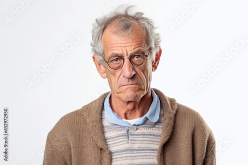 Medium shot portrait photography of a man in his 50s appearing tired and down due to hypothyroidism wearing a chic cardigan against a white background  © Leon Waltz