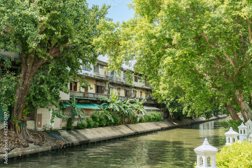 Retro old buildings and canal river with green forest in Bangkok, Thailand