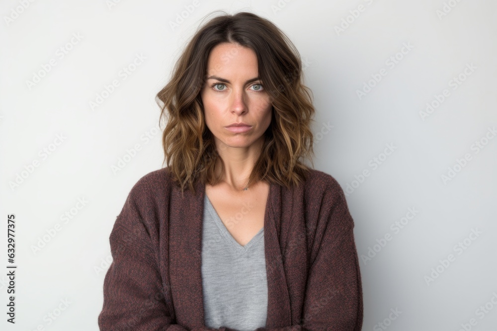 Medium shot portrait photography of a woman in her 30s with a somber and deeply sad expression due to major depression wearing a chic cardigan against a white background Medium shot portrait photography of a woman in her 30s with a somber and deeply sad expression due to major depression wearing a chic cardigan against a white background