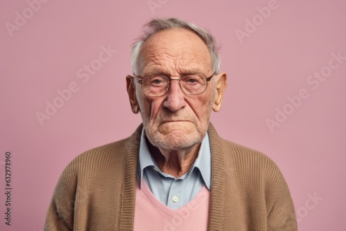Group portrait photography of a man in his 80s with a somber and deeply sad expression due to major depression wearing a chic cardigan against a pastel or soft colors background 