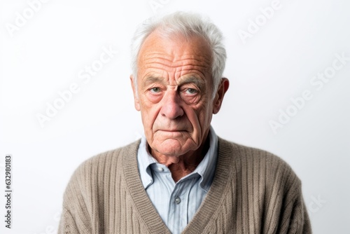 Medium shot portrait photography of a man in his 90s looking anxious and fidgety due to generalized anxiety disorder wearing a chic cardigan against a white background  © Leon Waltz