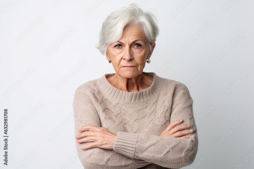 Group portrait photography of a woman in her 70s visibly in discomfort and fatigue from an autoimmune disease like lupus wearing a cozy sweater against a white background Group portrait photography of a woman in her 70s visibly in discomfort and fatigue from an autoimmune disease like lupus wearing a cozy sweater against a white background