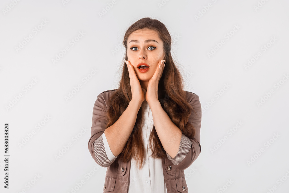 Portrait of young scared woman. Amazed horrified female keeps hands on mouth, being shocked to be expelled from university, look at camera, stand over white studio background Portrait of young scared woman. Amazed horrified female keeps hands on mouth, being shocked to be expelled from university, look at camera, stand over white studio background