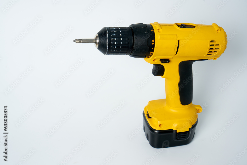 Black and yellow cordless drill on a white isolated background. Black and yellow cordless drill on a white isolated background.
