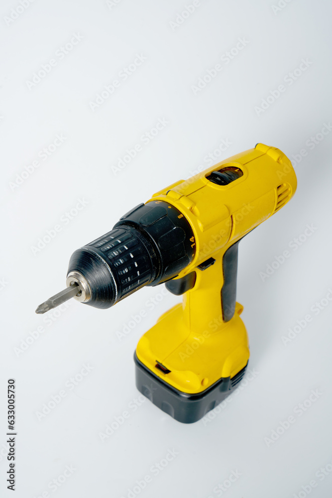 Black and yellow cordless drill on a white isolated background. Black and yellow cordless drill on a white isolated background.