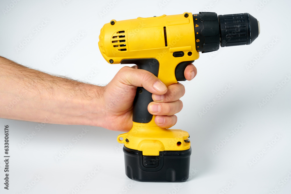Black and yellow cordless drill on a white isolated background. Black and yellow cordless drill on a white isolated background.