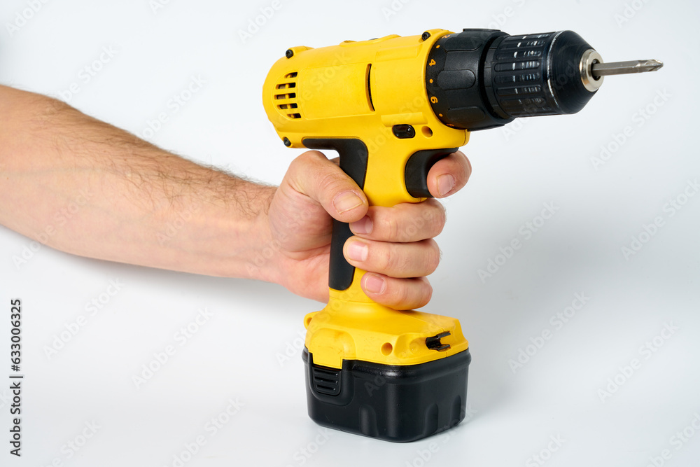 Black and yellow cordless drill on a white isolated background. Black and yellow cordless drill on a white isolated background.
