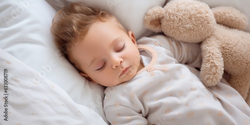 Cute baby resting and napping during daytime nap at home.