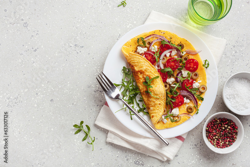 omelette with tomato, feta cheese onion and arugula. healthy keto diet low carb breakfast
