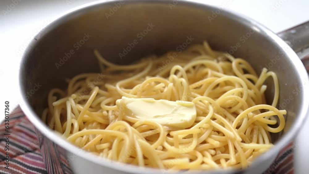 cooked spaghetti with butter in saucepan cooked spaghetti with butter in saucepan