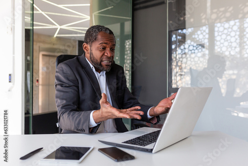 Dissatisfied and upset african american man at workplace, mature experienced boss disappointed with financial results of achievement inside office, bankrupt banker investor.