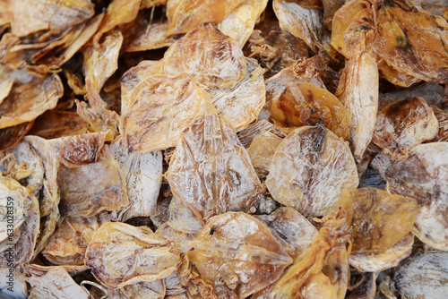 Dried salted fish as a background. Close-up.