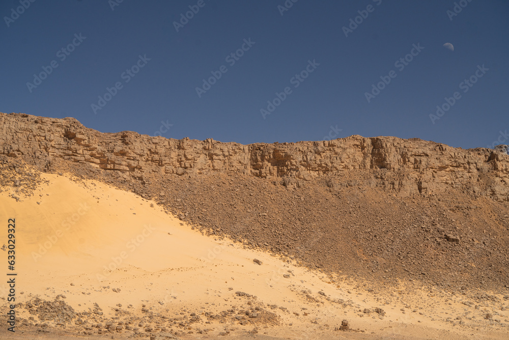 Fototapeta premium view in the Sahara desert of Tadrart rouge tassili najer in Djanet City ,Algeria.colorful orange sand, rocky mountains