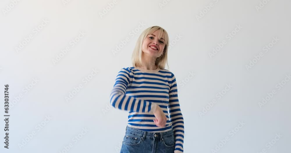 Attractive woman is seen on a white backdrop, extending her hand and gesturing with a welcoming smile, as if inviting someone to join her. Her inviting expression and open body language convey warmth. Attractive woman is seen on a white backdrop, extending her hand and gesturing with a welcoming smile, as if inviting someone to join her. Her inviting expression and open body language convey warmth.