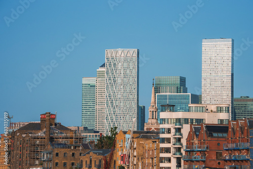 Modern skyscrapers in city. Financial office building and residential structure with blue sky in background. Glass windows on modern structure in downtown district of London.