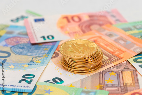 A Stack of Bitcoin Coins on the Euro Banknotes. Money Saving, Cryptocurrency, Blockchain and Anonymous Payments Concept