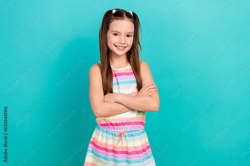Photo of adorable funny school girl pupil age wear fashion striped summer dress sarafan isolated aquamarine color background Photo of adorable funny school girl pupil age wear fashion striped summer dress sarafan isolated aquamarine color background