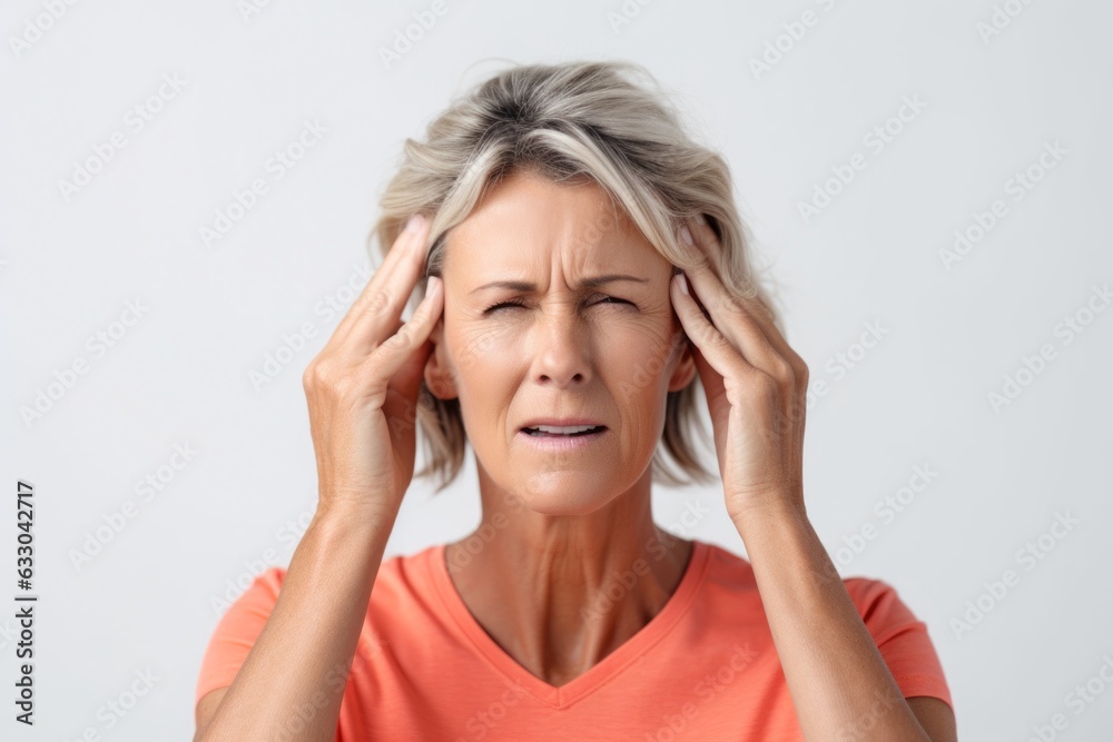 Portrait of a mature woman suffering from headache isolated on a white background Portrait of a mature woman suffering from headache isolated on a white background