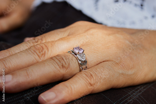 Zoom View Woman's Hand with Pink Diamond Wedding Ring photo