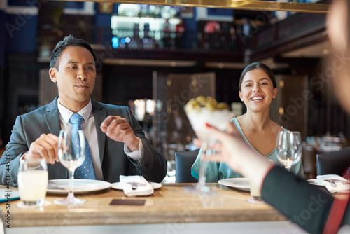 Businesspeople at bar of restaurant photo