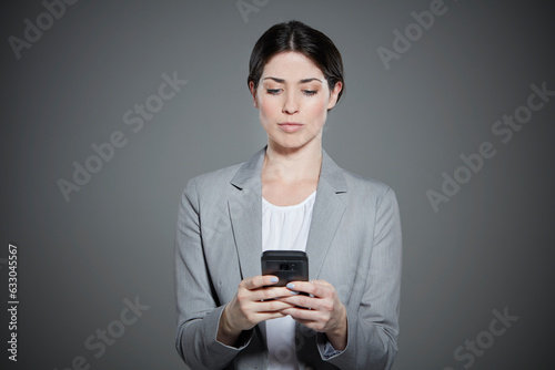Portrait of young woman text messaging.