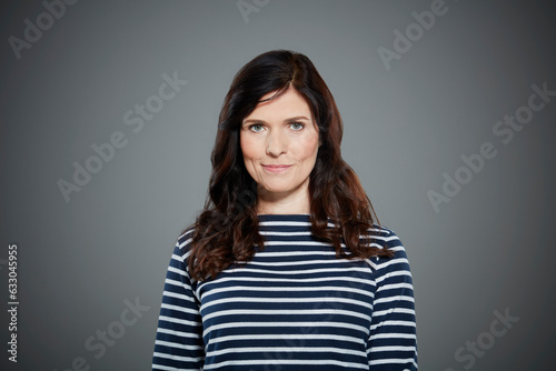 Portrait of mid adult woman wearing striped shirt.