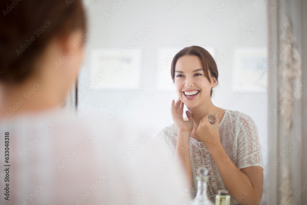 Mid adult woman looking at herself in mirror. Mid adult woman looking at herself in mirror.