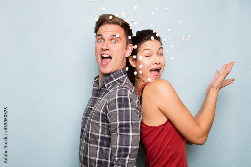 Couple throwing marshmallows Couple throwing marshmallows