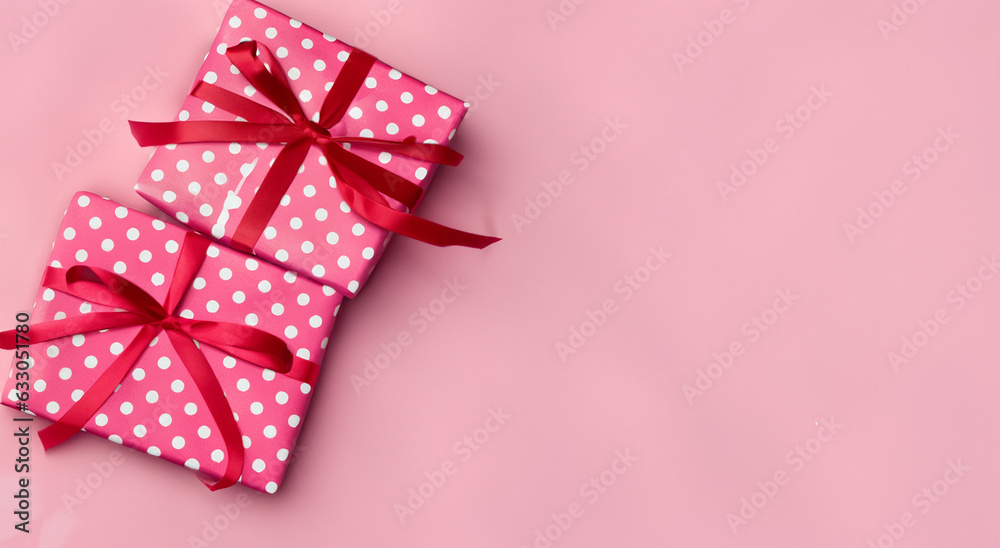 pink gift box with white dots with pink ribbon on pastel pink background pink gift box with white dots with pink ribbon on pastel pink background
