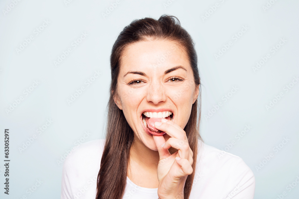 Young woman eating cookie Young woman eating cookie
