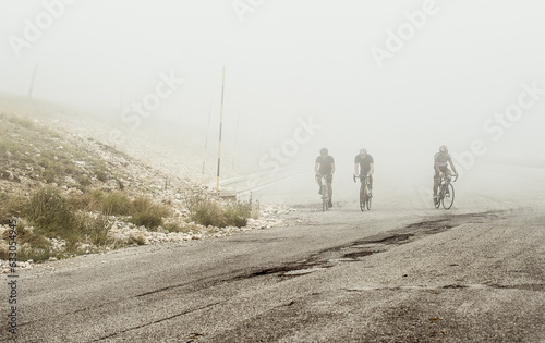 Cyclists under fog in Pretoro, Italy
