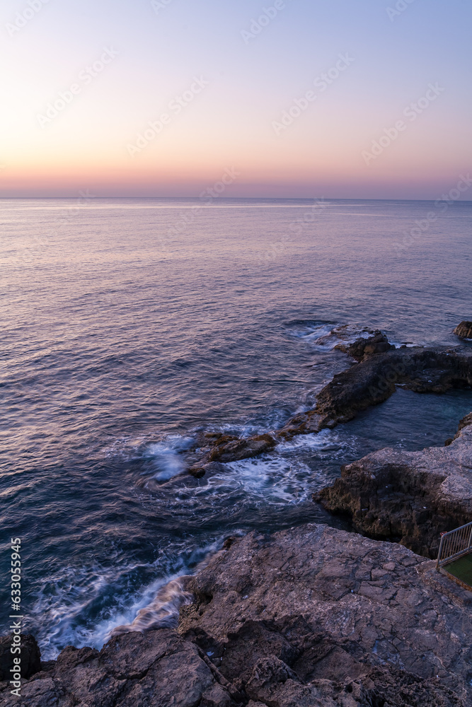 Sunset on horizon with water on rocks