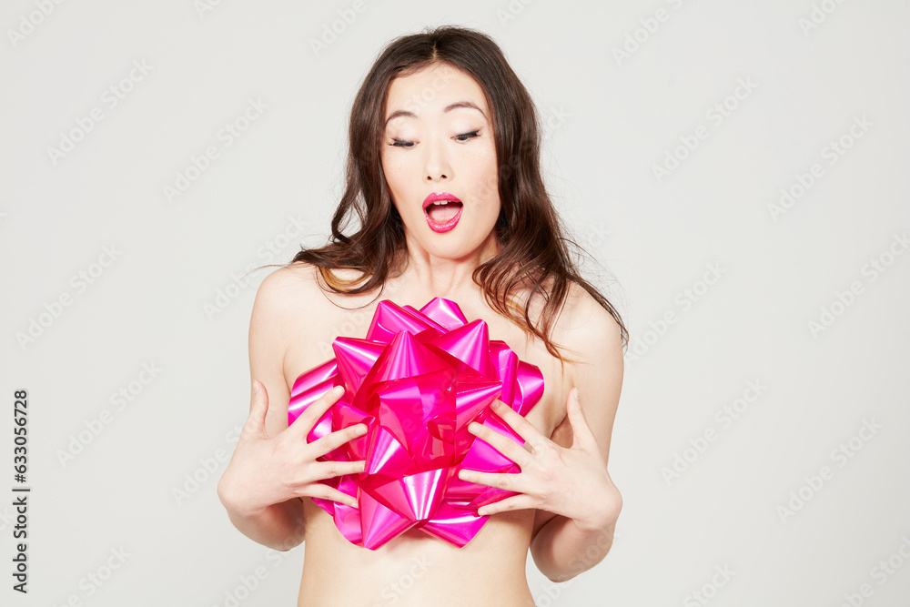 Shirtless woman covered with pink gift bow Shirtless woman covered with pink gift bow