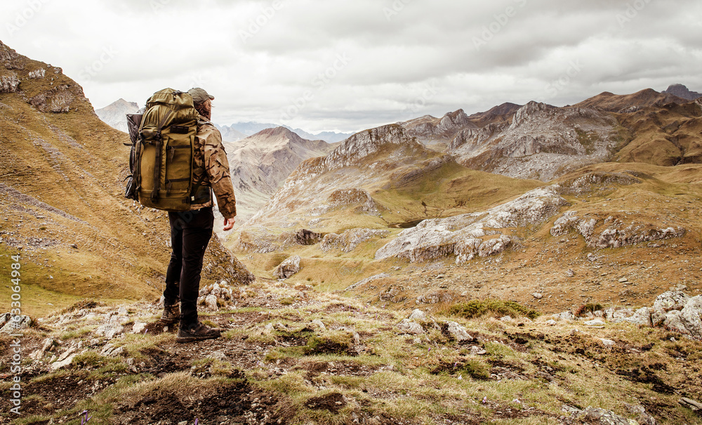 Man admiring view of valley during hike Man admiring view of valley during hike