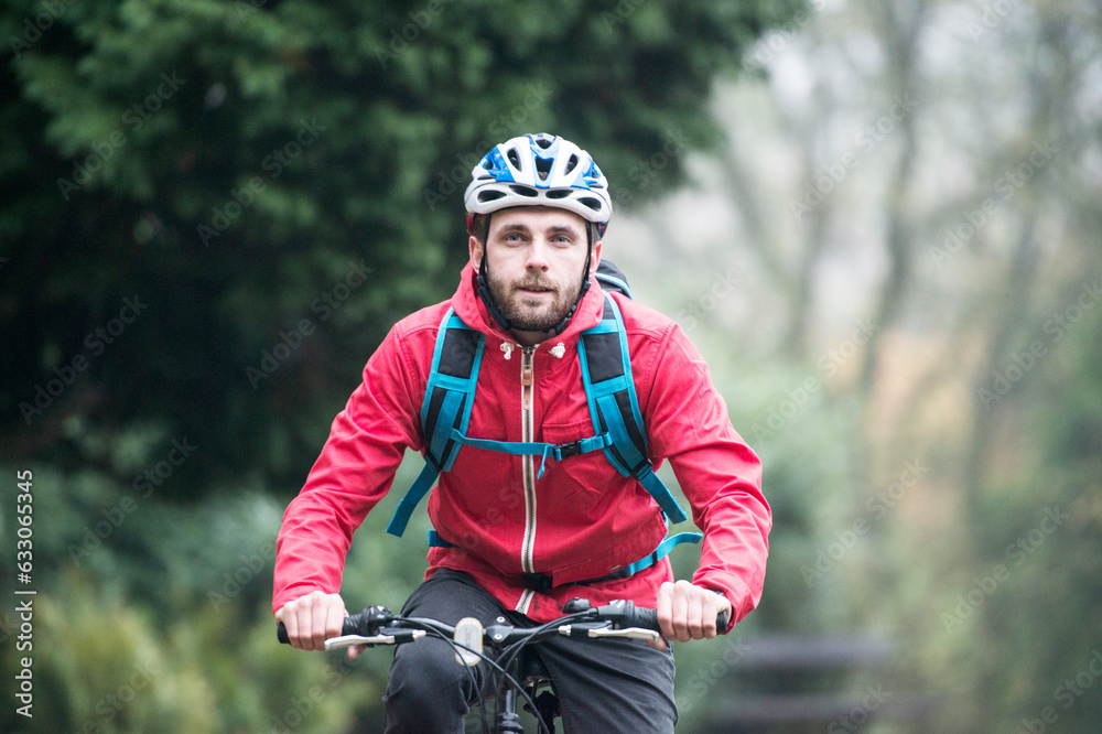 Man in red jacket commuting by bicycle Man in red jacket commuting by bicycle